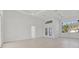 Spacious living room featuring bright lighting, tray ceilings, and expansive windows at 2551 Alhaven Ter, North Port, FL 34286