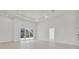 Bright living room with tray ceiling, recessed lights and sliding glass doors to outside at 2551 Alhaven Ter, North Port, FL 34286