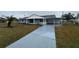 Charming single story home featuring a covered carport and a well-manicured front yard at 702 Desert Hills Way, Sun City Center, FL 33573