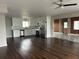 Well lit kitchen featuring stainless steel appliances, granite countertops, white cabinets, and hardwood flooring at 702 Desert Hills Way, Sun City Center, FL 33573