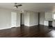 Open concept living room featuring ceiling fan, hardwood floors, and great natural light at 702 Desert Hills Way, Sun City Center, FL 33573