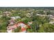 Aerial view of the home showcasing its location within a lush, green neighborhood and the proximity to mature trees at 1481 Newton St, Port Charlotte, FL 33952