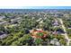 Aerial view of the home nestled among mature trees and landscaping, showcasing property lines at 1481 Newton St, Port Charlotte, FL 33952