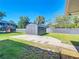 Landscaped backyard with a shed and a newly-installed wooden deck, perfect for outdoor entertaining at 1481 Newton St, Port Charlotte, FL 33952