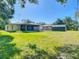 Expansive backyard with a shed, screened-in patio, and lush green grass, perfect for outdoor living at 1481 Newton St, Port Charlotte, FL 33952