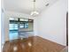 Bright dining room with hardwood floors, chandelier, and a view into the sunroom at 1481 Newton St, Port Charlotte, FL 33952