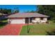 Charming single-story home with a well-maintained lawn, mature landscaping, and inviting curb appeal at 1481 Newton St, Port Charlotte, FL 33952
