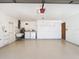 Spacious garage with washer, dryer, laundry sink, shelving and bright lighting at 1481 Newton St, Port Charlotte, FL 33952