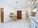 Open kitchen with a folding table, tile flooring, and a view into the dining area at 1481 Newton St, Port Charlotte, FL 33952