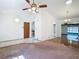 Spacious living room with carpet, tile flooring, and multiple entrances to other rooms at 1481 Newton St, Port Charlotte, FL 33952