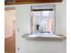 Kitchen pass-through with a marble counter, sink, and a view into another area of the home at 1481 Newton St, Port Charlotte, FL 33952