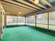 Relaxing screened-in patio featuring vibrant green turf and an exposed beam ceiling at 1481 Newton St, Port Charlotte, FL 33952