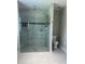 Large walk-in shower features tiled walls, glass doors, and multiple shower heads at 2137 Apian Way, Port Charlotte, FL 33953