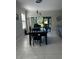 Dining room features a dark wood table with seating for four and sliding glass doors to the backyard at 2137 Apian Way, Port Charlotte, FL 33953