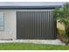 This is a view of the side of the house featuring hurricane shutter panels at 2137 Apian Way, Port Charlotte, FL 33953