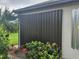 This is a view of the side of the house featuring hurricane shutter panels at 2137 Apian Way, Port Charlotte, FL 33953