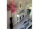 Inviting foyer with a decorative table, mirror, and a view into the living area at 2137 Apian Way, Port Charlotte, FL 33953