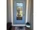 View of a glass front door with welcome mat and decorative accents at 2137 Apian Way, Port Charlotte, FL 33953