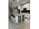 Bright kitchen features a spacious island with seating and ample storage space at 2137 Apian Way, Port Charlotte, FL 33953