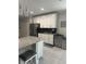 This kitchen features stainless steel appliances, white cabinets, and a speckled granite countertop island at 2137 Apian Way, Port Charlotte, FL 33953