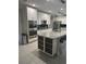 Well-lit kitchen features stainless steel appliances, white cabinets, and a large island with seating at 2137 Apian Way, Port Charlotte, FL 33953