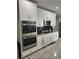 Modern kitchen with stainless steel appliances, granite countertops, and white cabinetry at 2137 Apian Way, Port Charlotte, FL 33953