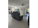 Open-concept living room boasts tile flooring, recessed lighting, and a comfortable gray sectional sofa at 2137 Apian Way, Port Charlotte, FL 33953