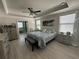 Cozy main bedroom features a tray ceiling, ceiling fan, and ensuite bathroom at 2137 Apian Way, Port Charlotte, FL 33953