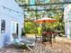 Outdoor patio with lounge chair, dining table, grill, and stylish string lights at 2806 W Shelton Ave, Tampa, FL 33611