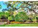 Lush backyard with a small bridge and a variety of trees at 2806 W Shelton Ave, Tampa, FL 33611