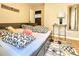 Cozy bedroom with decorative pillows on the bed, a side table with a lamp, and a colorful rug at 2806 W Shelton Ave, Tampa, FL 33611