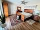 Spacious bedroom with wooden furniture, decorative rugs, and a ceiling fan at 2806 W Shelton Ave, Tampa, FL 33611