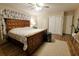 Bright bedroom with patterned curtains, double closets, ceiling fan, and wooden bed frame at 2806 W Shelton Ave, Tampa, FL 33611