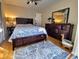 Comfortable bedroom featuring a well-lit space, wooden furniture, and a patterned blue and white bedspread at 2806 W Shelton Ave, Tampa, FL 33611