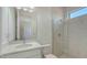Modern bathroom with a glass-enclosed shower, tiled walls, and a vanity with a countertop sink at 18213 Cresswind Ter, Lakewood Ranch, FL 34211