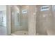 Luxurious bathroom featuring a glass-enclosed shower with modern fixtures and bench seating at 18213 Cresswind Ter, Lakewood Ranch, FL 34211
