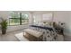 Comfortable bedroom featuring a large window with scenic views and stylish decor at 18213 Cresswind Ter, Lakewood Ranch, FL 34211