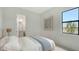 Cozy bedroom with a view, featuring calming decor and an ensuite bathroom at 18213 Cresswind Ter, Lakewood Ranch, FL 34211