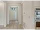 Inviting entryway with neutral paint, wood floors, and stainless steel appliances in the adjacent kitchen at 18213 Cresswind Ter, Lakewood Ranch, FL 34211