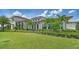 Luxury clubhouse exterior with lush landscaping and inviting architectural details providing beautiful curb appeal at 18213 Cresswind Ter, Lakewood Ranch, FL 34211