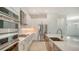 A modern kitchen featuring stainless steel appliances, white cabinets, quartz countertops, and a central island at 18213 Cresswind Ter, Lakewood Ranch, FL 34211