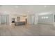 Open-concept living space with wood flooring and a kitchen featuring stainless steel appliances and a kitchen island at 18213 Cresswind Ter, Lakewood Ranch, FL 34211