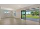 Living room with sleek wood flooring, a modern chandelier, and sliding glass doors to the outdoors at 18213 Cresswind Ter, Lakewood Ranch, FL 34211