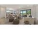 Inviting living room with an open floor plan, modern furnishings, and a view of the outdoor patio at 18213 Cresswind Ter, Lakewood Ranch, FL 34211