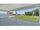 Covered outdoor patio featuring a stone tile floor overlooking a grassy lawn at 18213 Cresswind Ter, Lakewood Ranch, FL 34211