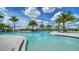 Resort-style pool with clear blue water, surrounded by palm trees and comfortable lounge seating for relaxation at 18213 Cresswind Ter, Lakewood Ranch, FL 34211
