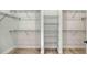 Walk-in closet featuring metal shelving and wood flooring at 18213 Cresswind Ter, Lakewood Ranch, FL 34211