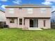 Spacious backyard with well-maintained lawn, patio, and sliding glass doors enhancing indoor-outdoor living at 2007 Rain Dance Pl, Brandon, FL 33510
