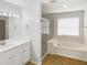 Clean and bright bathroom featuring a separate shower and soaking tub, with white cabinets at 2007 Rain Dance Pl, Brandon, FL 33510