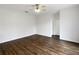 Spacious, modern bedroom with sleek hardwood floors, white walls, and a pair of closets for ample storage at 2007 Rain Dance Pl, Brandon, FL 33510